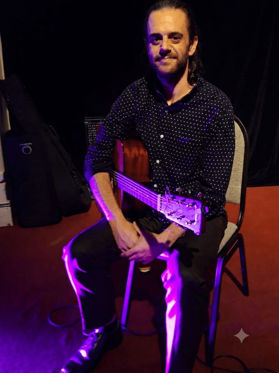 Finbar Maginn holding a guitar
